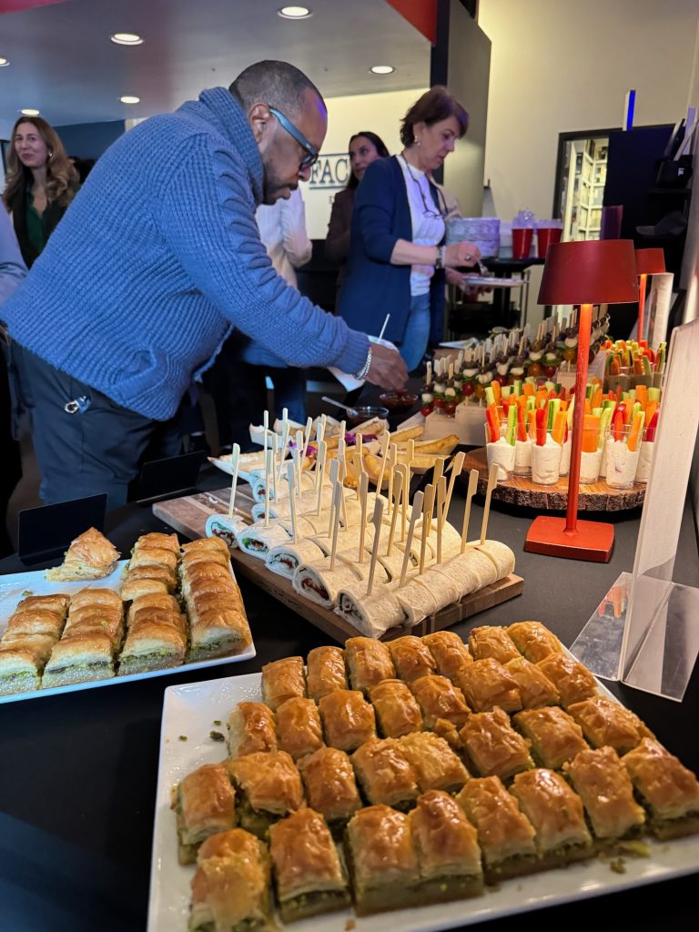 Guests getting food provided by Anatolia restaurant