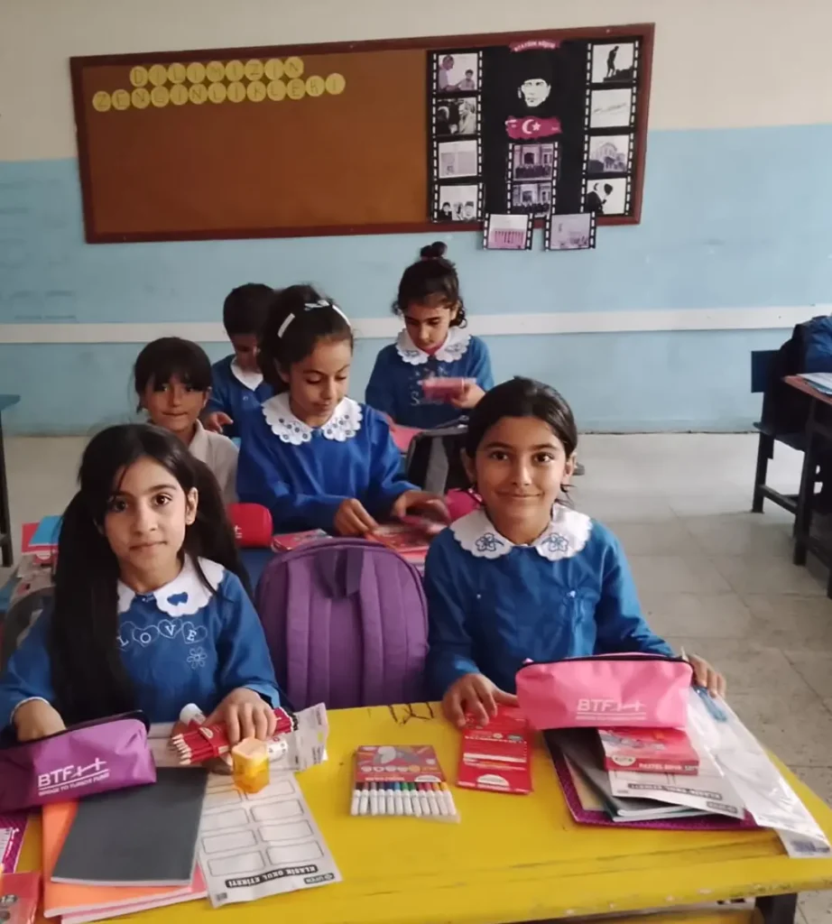 Students at Azıklı Elementary School in Şanlıurfa, Türkiye, sit at their desks with new backpacks, pencil cases, notebooks, and art supplies provided through BTF's Back to School Campaign.