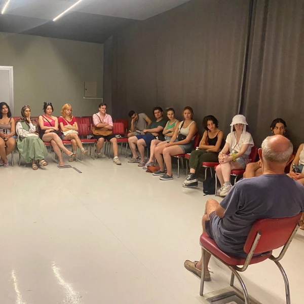 Participants of the 2025 Nâzım Hikmet Summer Camp sit in a circle during an indoor group discussion in Büyükada, Istanbul.